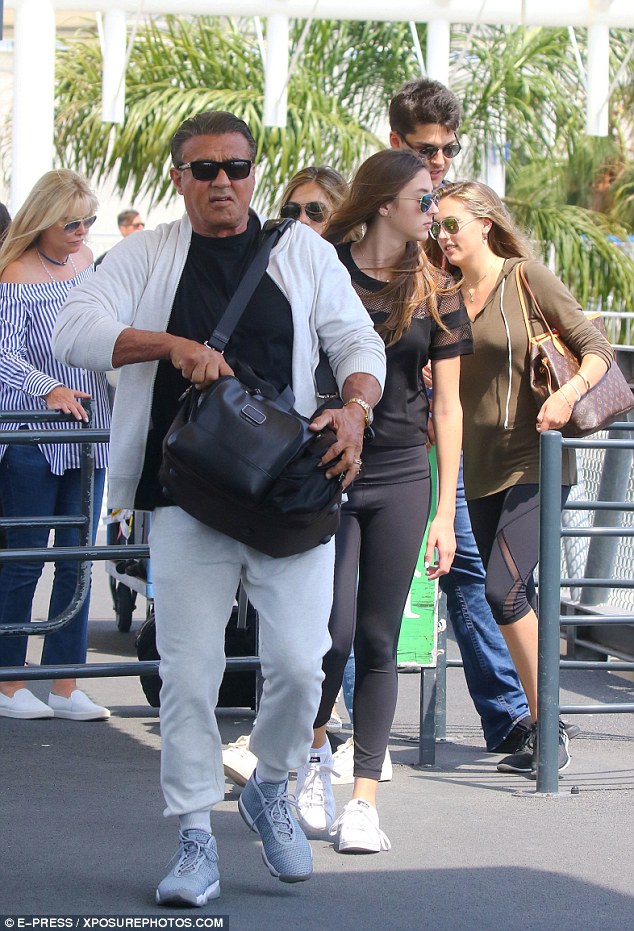 Arriving in style: Sylvester Stallone was in great spirits as he touched down in the South of France, arriving at Nice airport on Tuesday afternoon