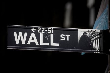 The Wall St. sign is seen near the New York Stock Exchange (NYSE) in New York City, U.S., March 29, 2021. REUTERS/Brendan McDermid