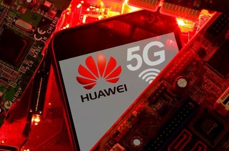 A smartphone with the Huawei and 5G network logo is seen on a PC motherboard in this illustration picture taken January 29, 2020. REUTERS/Dado Ruvic