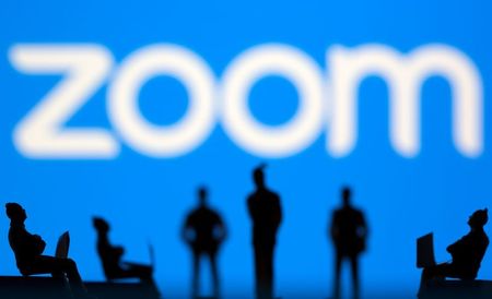 Small toy figures are seen in front of Zoom logo in this illustration picture taken March 15, 2021. REUTERS/Dado Ruvic/Illustration