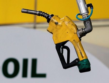 FILE PHOTO: A gas pump is seen hanging from the ceiling at a petrol station in Seoul June 27, 2011. REUTERS/Jo Yong-Hak/File Photo