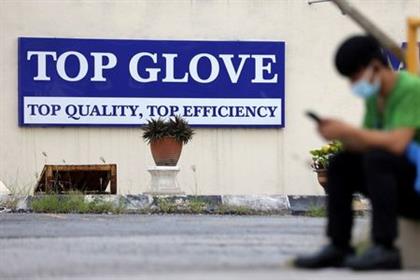 FILE PHOTO: Top Glove logo is pictured outside a factory in Klang, Malaysia December 10, 2020. REUTERS/Lim Huey Teng 