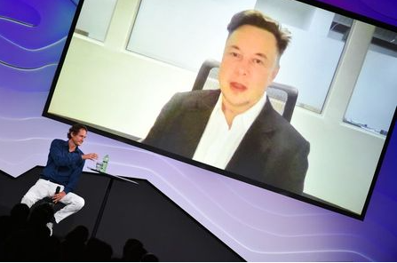 Chairman of Stellantis and Ferrari John Elkann speaks via video conference with Tesla's founder Elon Musk during the 
