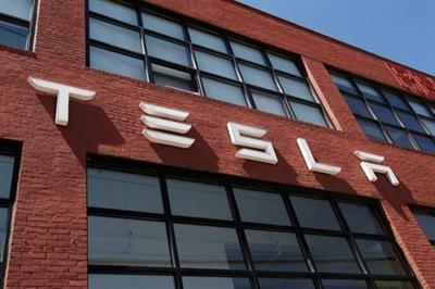 The TESLA logo is seen outside a dealership in the Brooklyn borough of New York City, U.S., April 26, 2021. REUTERS/Shannon Stapleton