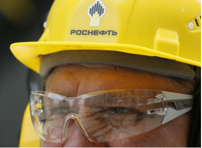 An employee wears a helmet with the logo of Rosneft at the Achinsk refinery, which was acquired by Rosneft company in 2007 and currently processes West Siberian crude delivered via the Transneft pipeline system, in Krasnoyarsk Region, Russia July 23, 2018. Picture taken July 23, 2018. REUTERS/Ilya Naymushin