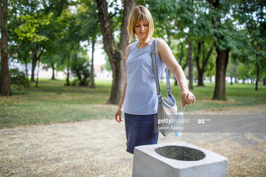 throwing mask into trash