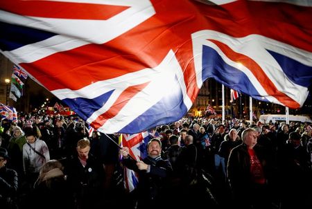 A man waves a British flag on Brexit day in London, Britain, January 31, 2020. REUTERS/Henry Nicholls/File Photo TPX IMAGES OF THE DAY SEARCH "GLOBAL POY" FOR THIS STORY. SEARCH "REUTERS POY" FOR ALL BEST OF 2020 PACKAGES.