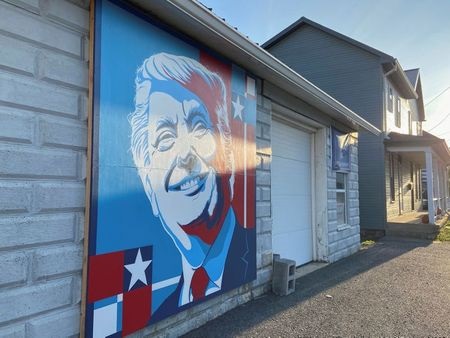A mural of a smiling U.S. President Donald Trump commissioned by Randy Bunch, a commissioner in Fulton County, is seen on the side of a business on Election Day in McConnellsburg, Pennsylvania November 3, 2020. Picture taken November 3, 2020. REUTERS/Nathan Layne
