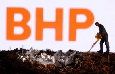 FILE PHOTO: A small toy figure and mineral imitation are seen in front of the BHP logo in this illustration taken November 19, 2021. REUTERS/Dado Ruvic/Illustration/File Photo