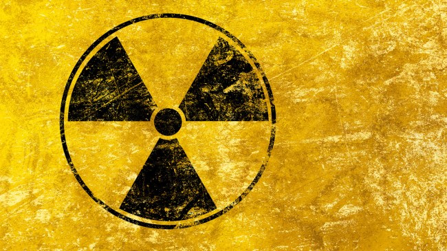 Black radioactive sign over yellow background