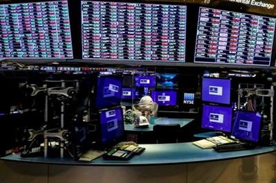 FILE PHOTO: Dividers are seen inside a trading post on the trading floor as preparations are made for the return to trading at the New York Stock Exchange (NYSE), May 22, 2020. REUTERS/Brendan McDermid/File Photo
