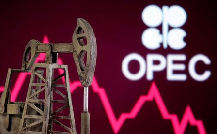 A 3D printed oil pump jack is seen in front of displayed stock graph and Opec logo in this illustration picture, April 14, 2020. REUTERS/Dado Ruvic/Illustration