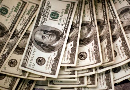 U.S. dollars are counted by a banker at a bank in Westminster, Colorado November 3, 2009. REUTERS/Rick Wilking