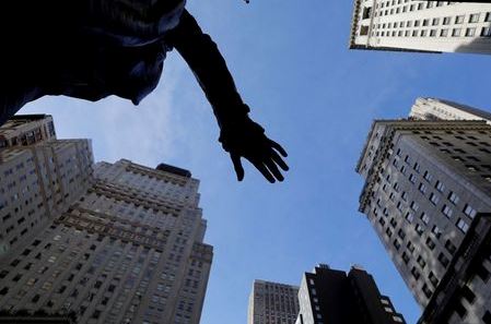 The hand of a sculpture of former U.S. President George Washington is pictured with the facade of the New York Stock Exchange (NYSE) building after the start of Thursday's trading session in Manhattan in New York City, New York, U.S., January 28, 2021. REUTERS/Mike Segar TPX IMAGES OF THE DAY
