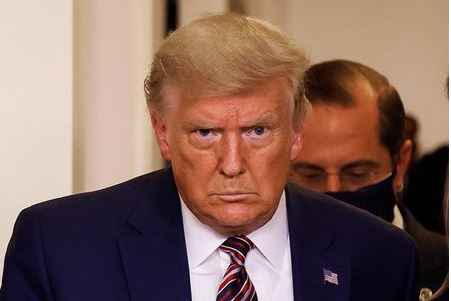 U.S. President Donald Trump is followed by HHS Secretary Alex Azar as he arrives to speak about prescription drug prices during an appearance in the Brady Press Briefing Room at the White House in Washington, U.S., November 20, 2020. REUTERS/Carlos Barria