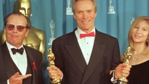 Clint Eastwood holds up his two Oscars at the 65th Annual Academy Awards 29 March 1993 that he won for Best Director and Best Picture for "Unforgiven". Eastwood poses with presenters, actor Jack Nicholson and entertainer Barbra Streisand.