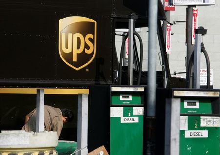 FILE PHOTO: A United Parcel Service (UPS) employee checks his vehicle at a UPS diesel fuel pump facility in Los Angeles, California July 22, 2008. REUTERS/Fred Prouser/File Photo