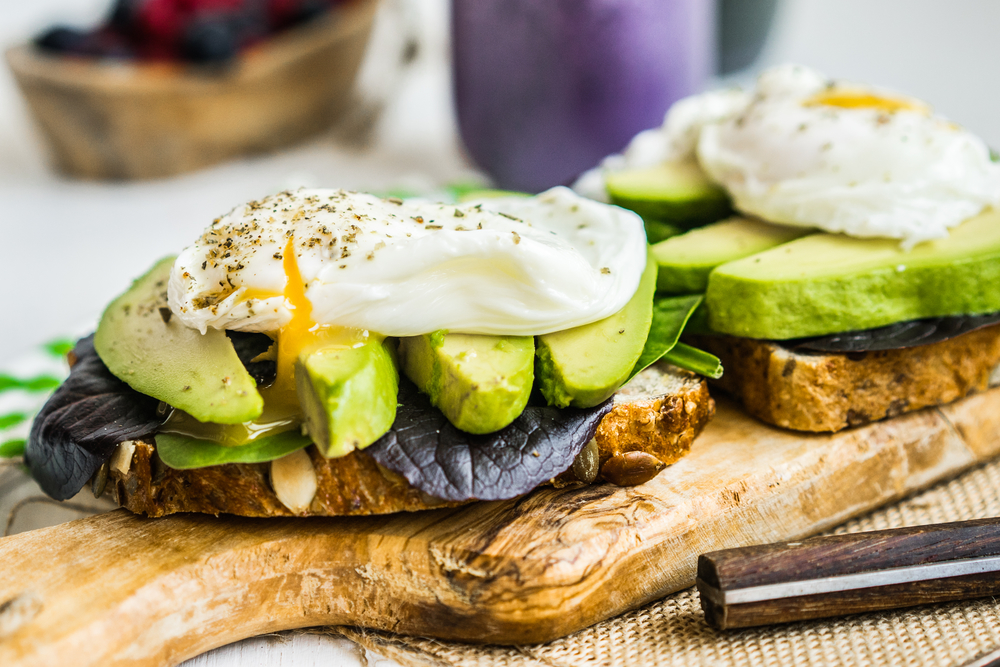 Healthy sandwich with avocado and poached eggs