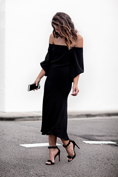 Модель в черном длинном платье без плеч и босоножки