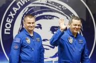 Members of the International Space Station (ISS) crew (L to R) Alexey Ovchinin and Oleg Skriprochka of Russia walk in front of a portrait of Yuri Gagarin, the first man in space, after a news conference behind a glass wall at the Baikonur cosmodrome, Kazakhstan, March 17, 2016, ahead of their launch scheduled on March 19. REUTERS/Shamil Zhumatov
