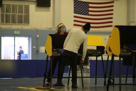 People vote at Santa Monica College gymnasium during the 2020 U.S. presidential election, in Santa Monica, California, U.S., November 3, 2020. REUTERS/Lucy Nicholson