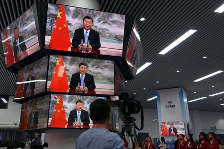 Chinese President Xi Jinping is seen on television screens at a media centre as he delivers a speech via video at the opening ceremony of the China International Import Expo (CIIE) in Shanghai, China November 4, 2021. REUTERS/Andrew Galbraith