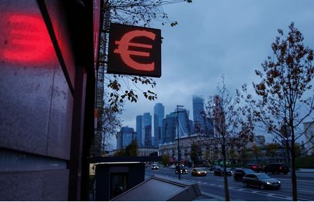 Advertisement board showing sign of the euro is seen next to skyscrapers of Moskva-City businesss district in Moscow, Russia November 2, 2020. REUTERS/Maxim Shemetov