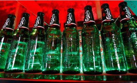 Bottles of Carlsberg beer are seen in a bar in St. Petersburg June 17, 2014. Denmark's Carlsberg will keep its breweries in Russia running regardless of empty capacity, despite other brewers closing plants as Western sanctions over Ukraine hamper an already faltering economy. To match Interview CARLSBERG-RUSSIA/ REUTERS/Alexander Demianchuk (RUSSIA - Tags: BUSINESS)