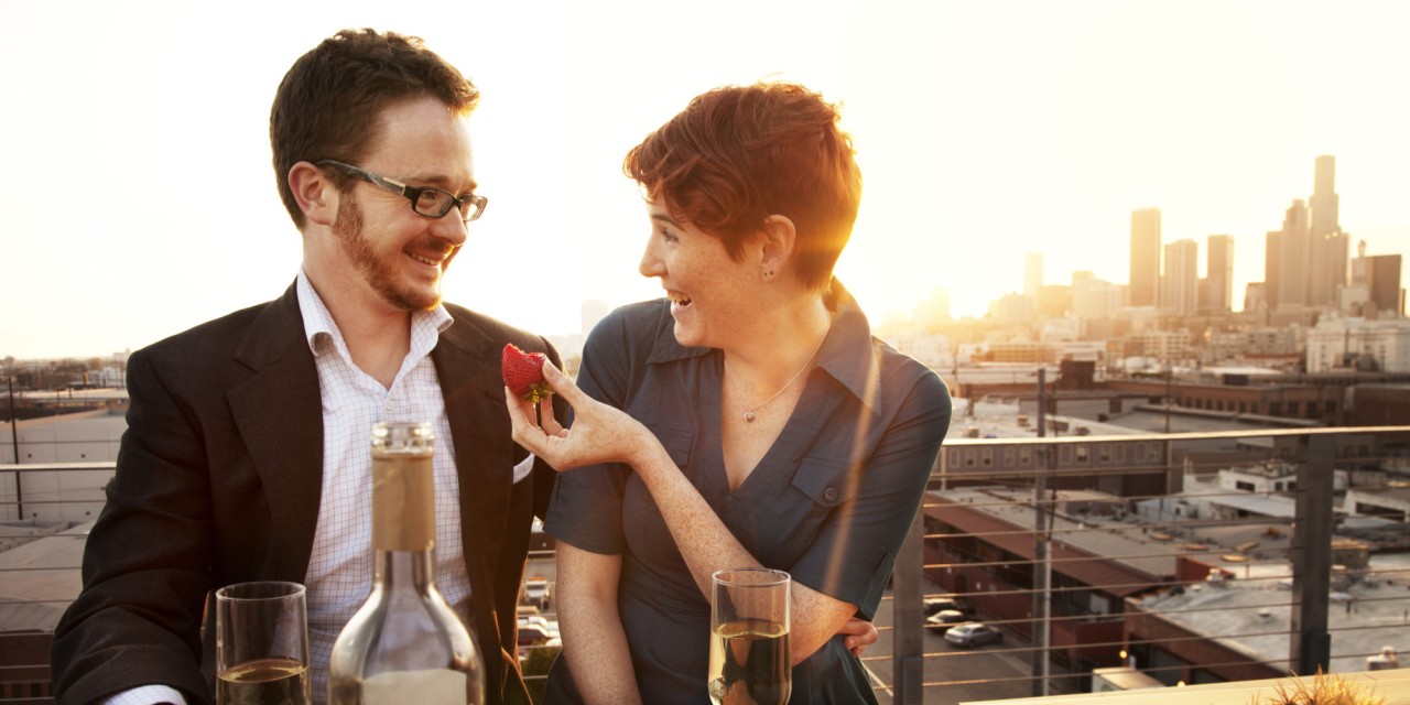 Couple on rooftop drinking wine