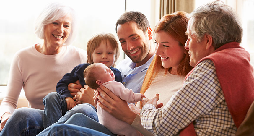 family visiting newborn baby