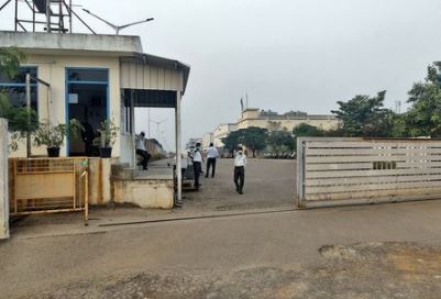 FILE PHOTO: Private security guards stand at the entrance of a closed plant of Foxconn India, which makes iPhones for Apple Inc, near Chennai, India, December 22, 2021. REUTERS/Sudarshan Varadhan