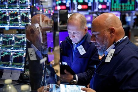 FILE PHOTO: Traders work on the floor of the New York Stock Exchange (NYSE) in New York City, U.S., November 29, 2021. REUTERS/Brendan McDermid