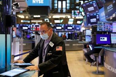 A trader works on the trading floor at the New York Stock Exchange (NYSE) in Manhattan, New York City, U.S., August 9, 2021. REUTERS/Andrew Kelly 
