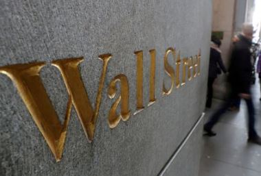 FILE PHOTO: A street sign, Wall Street, is seen outside New York Stock Exchange (NYSE) in New York City, New York, U.S., January 3, 2019. REUTERS/Shannon Stapleton/File Photo