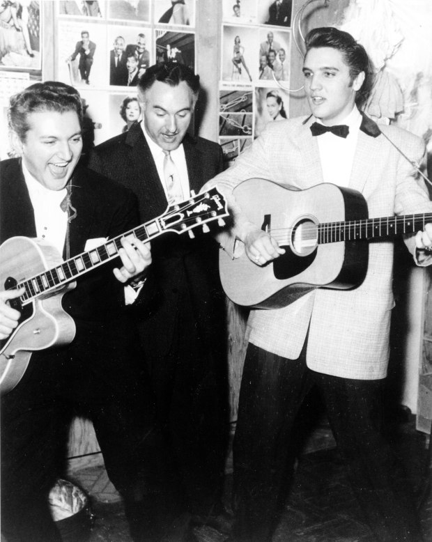 Liberace, left, is shown with his brother George Liberace, center, and Elvis Presley, at the New Frontier Hotel in Las Vegas on April 30, 1956. (AP Photo)