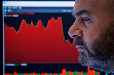 A trader works in his booth on the floor of the New York Stock Exchange (NYSE) in New York City, U.S., November 26, 2021. REUTERS/Brendan McDermid