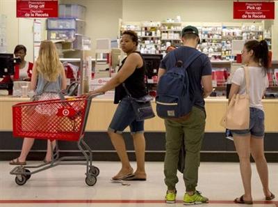 Customers shop in the pharmacy department of a Target store in the Brooklyn borough of New York June 15, 2015. Drugstore operator CVS Health Corp said it will acquire Target Corp's U.S. pharmacy and clinics businesses for about $1.9 billion to boost sales and prescription volumes. REUTERS/Brendan McDermid