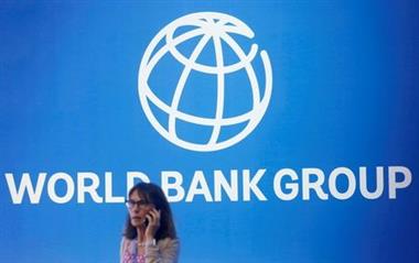 FILE PHOTO: A participant stands near a logo of World Bank at the International Monetary Fund - World Bank Annual Meeting 2018 in Nusa Dua, Bali, Indonesia, October 12, 2018. REUTERS/Johannes P. Christo/File Photo 