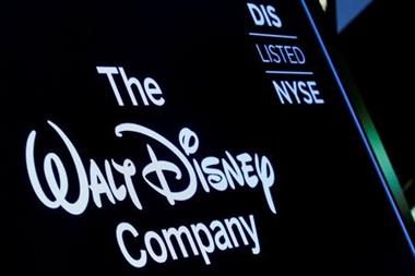 FILE PHOTO: FILE PHOTO: A screen shows the logo and a ticker symbol for The Walt Disney Company on the floor of the New York Stock Exchange (NYSE) in New York, U.S., December 14, 2017. REUTERS/Brendan McDermid/File Photo/File Photo