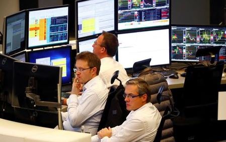Share traders look at their screens during early afternoon trading on the day of the Brexit deal vote of the British parliament at the stock exchange in Frankfurt, Germany, January 15, 2019. REUTERS/Kai Pfaffenbach
