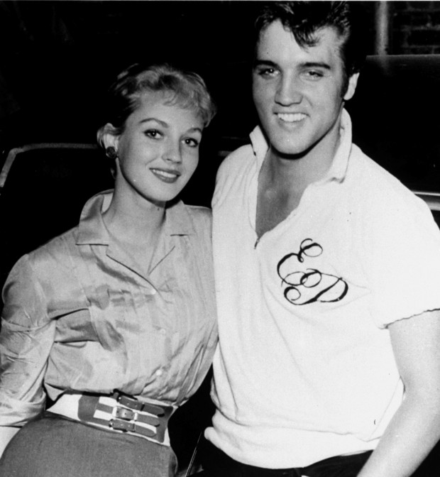 Elvis Presley, rock and roll singer turned movie actor, poses with house guest, Venetia Stevenson, Hollywood starlet recently dubbed 