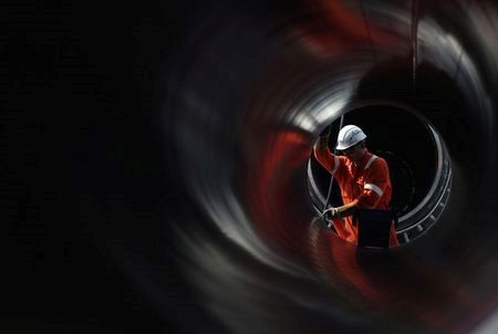 A worker is seen through a pipe at the construction site of the Nord Stream 2 gas pipeline, near the town of Kingisepp, Leningrad region, Russia, June 5, 2019. REUTERS/Anton Vaganov