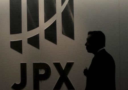 A man walks past the logo of Japan Exchange Group Inc. at the Tokyo Stock Exchange (TSE) in Tokyo August 26, 2015. Asian stocks fell on Wednesday as investors feared fresh rate cuts in China would not be enough to stabilize its cooling economy or halt a collapse in its stock markets. REUTERS/Yuya Shino 