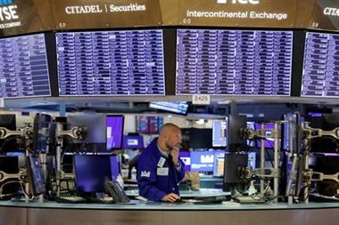 FILE PHOTO: A trader works on the trading floor at the New York Stock Exchange (NYSE) in Manhattan, New York City, U.S., August 9, 2021. REUTERS/Andrew Kelly/File Photo 