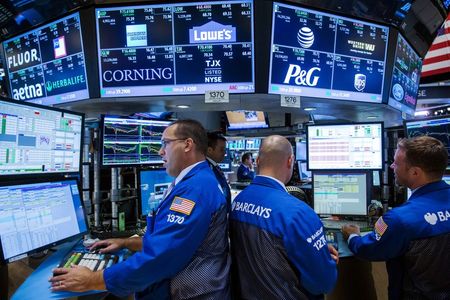 FILE PHOTO: Traders work on the floor of the New York Stock Exchange shortly before the closing bell in New York August 26, 2015. REUTERS/Lucas Jackson/File Photo