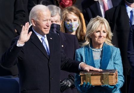 Joe Biden is sworn in as the 46th President of the United States as his wife Jill Biden holds a bible on the West Front of the U.S. Capitol in Washington, U.S., January 20, 2021. REUTERS/Kevin Lamarque TPX IMAGES OF THE DAY