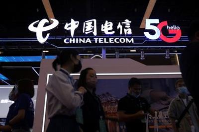People are seen at a China Telecom booth at an exhibition during China Internet Conference in Beijing, China, July 13, 2021. REUTERS/Tingshu Wang
