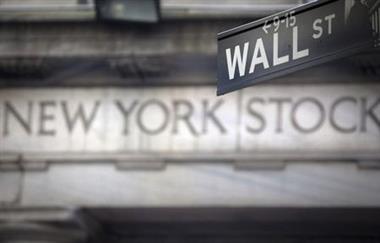 A Wall Street sign is pictured outside the New York Stock Exchange in New York, October 28, 2013. REUTERS/Carlo Allegri (UNITED STATES - Tags: BUSINESS) 