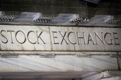 FILE PHOTO: "Stock Exchange" is seen over an entrance to the New York Stock Exchange (NYSE) on Wall St. in New York City, U.S., March 29, 2021. REUTERS/Brendan McDermid/File Photo