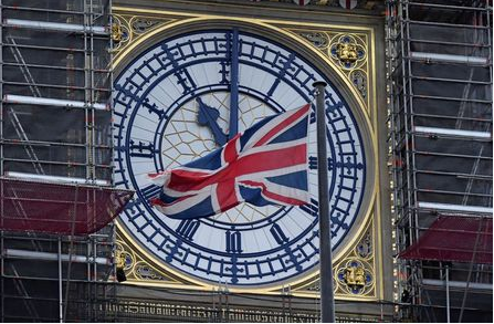 The British union flag is seen fluttering as the clock face of Big Ben shows eleven o'clock, London, January 30, 2020. REUTERS/Toby Melville
